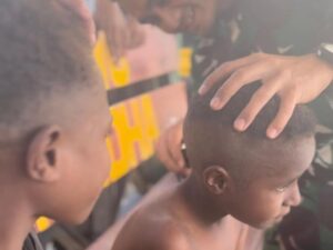 Anak-Anak Sekolah Senang Menerima Layanan Cukur Gratis di Titik Kuat Mamba Satgas Yonif 509 Kostrad